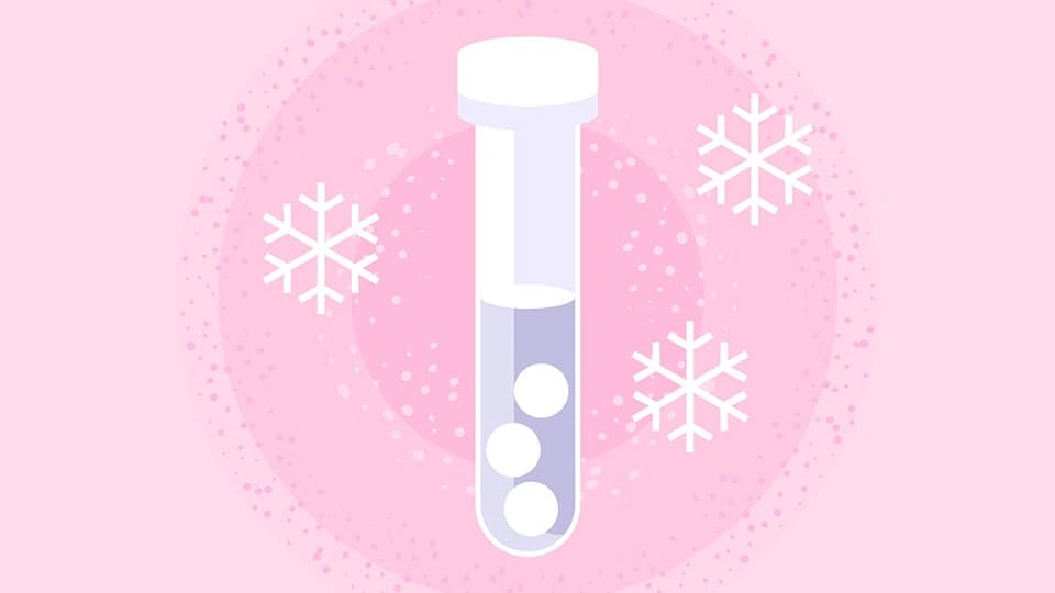An animated image of a single test tube surrounded by snowflakes to indicate egg freezing