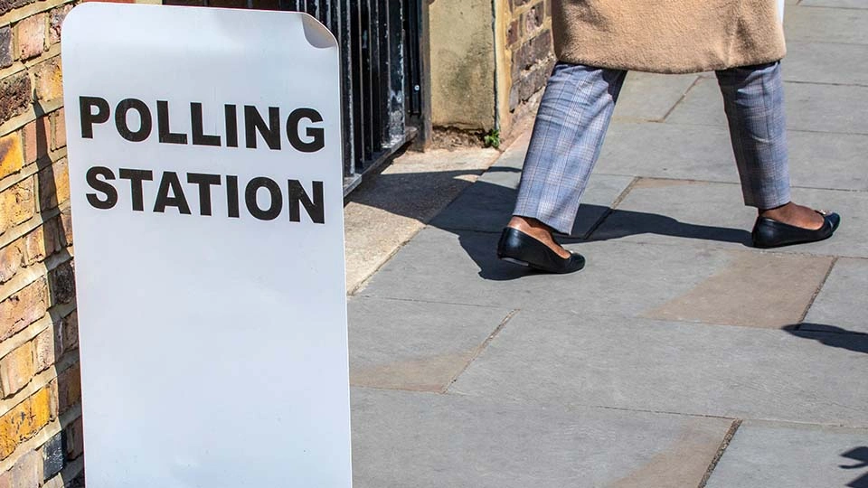 A woman walks out of a polling station
