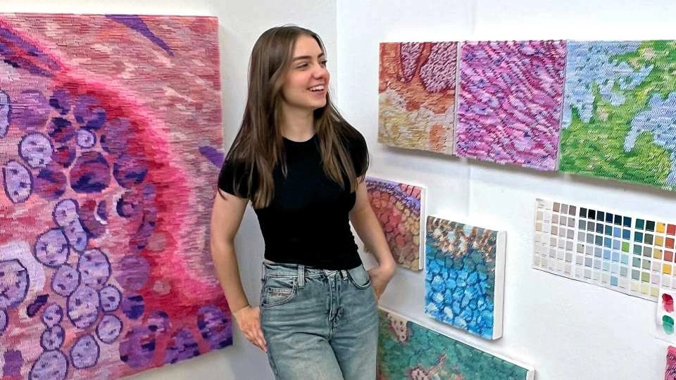 Jess Beaton stood in front of her art exhibit