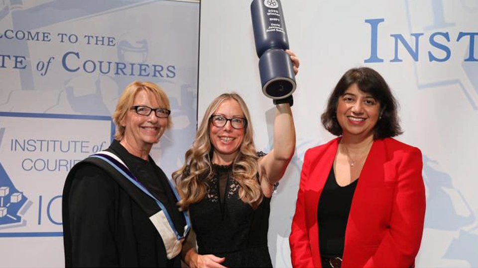 A group celebrating with a trophy
