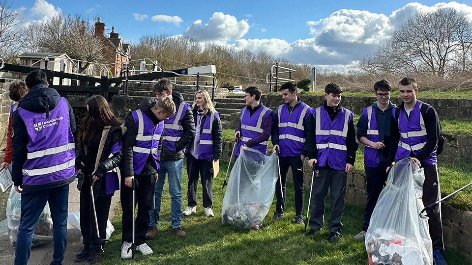 A group of students picking litter on the canal.