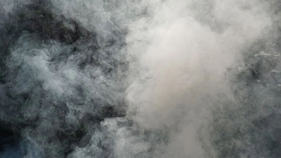 Plume of white smoke with a black background