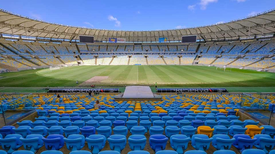 A view of a football stadium from one of the seats on a sunny day.