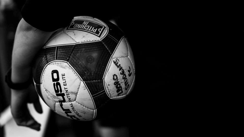 Black and white photograph of a football from the Team behind the Team exhibition