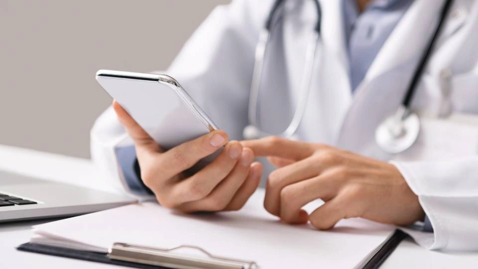 a doctor looking at a mobile phone