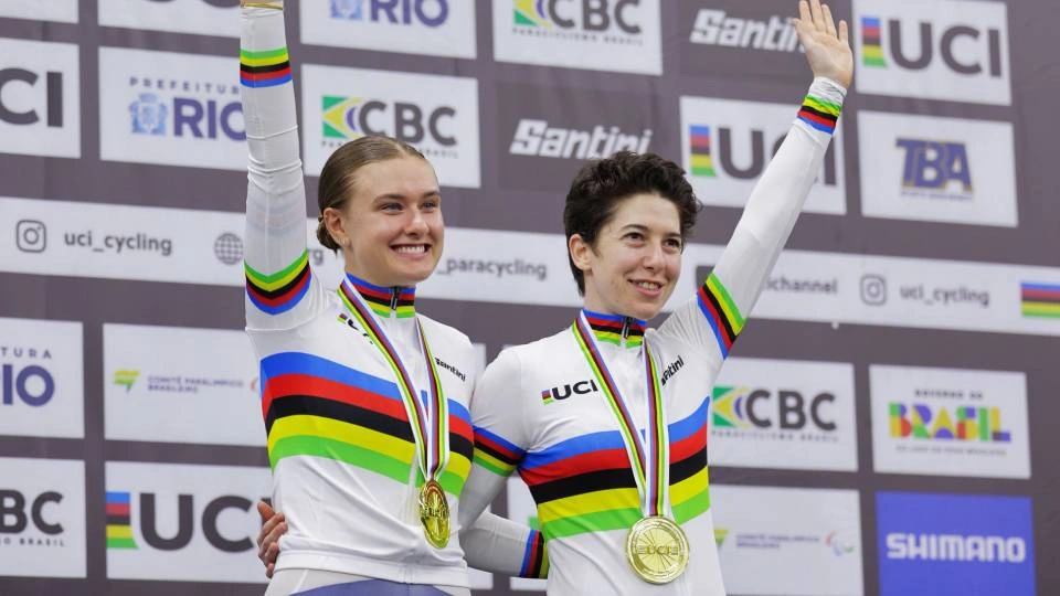 two athletes on a podium with medals