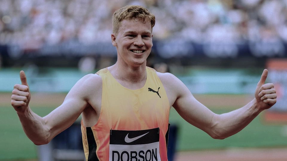 athlete charlie dobson after a race with this thumbs up