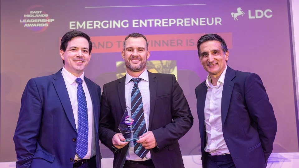 Adriano Randi holding his award with Alex Turner and David Bains.