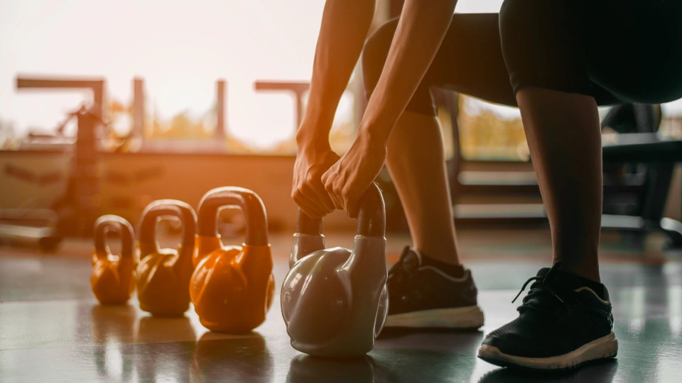 kettle bell weights in a row on the gym floor