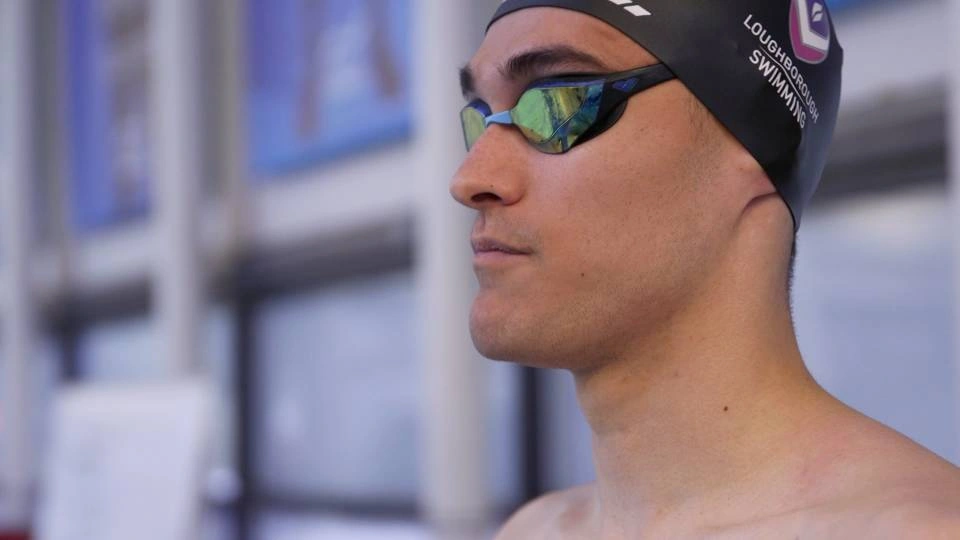 a close up of swimmer henry hughes