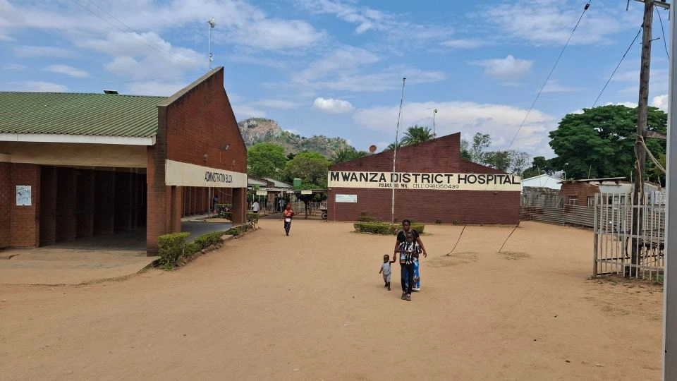 People walking outside of Mwanza District Hospital in Malawi.