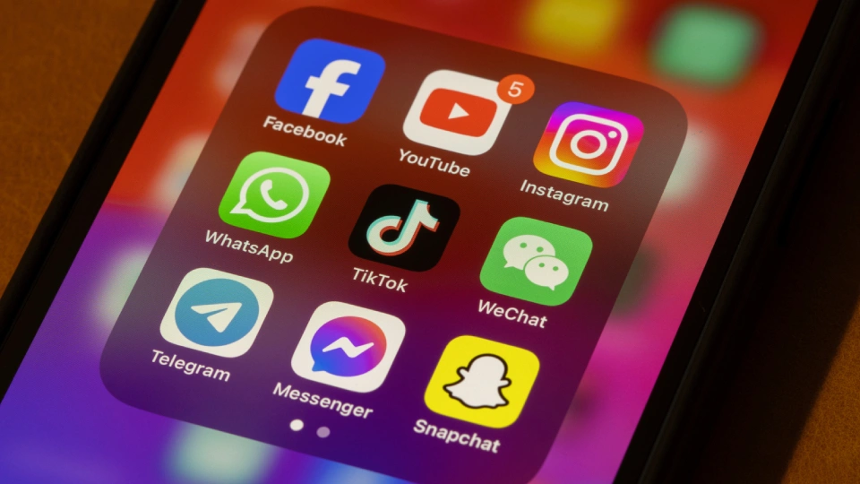 social media icons displayed on a phone