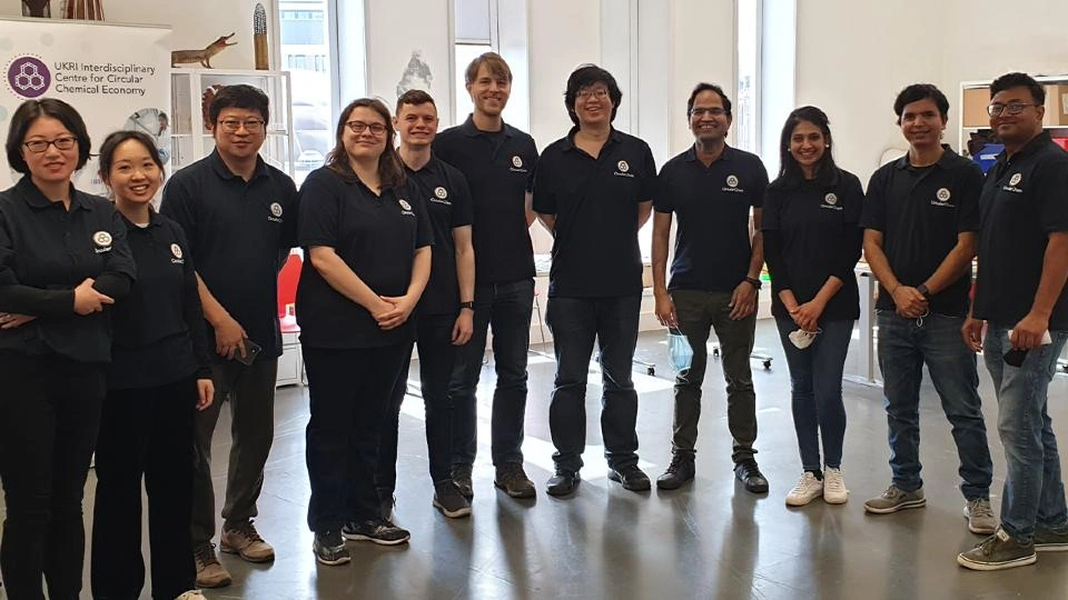 Members of the Centre for Circular Chemical Economy team stood together smiling at the camera inside