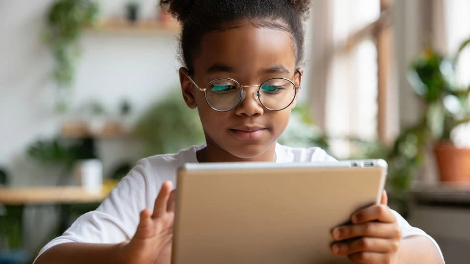 Child interacts with tablet device