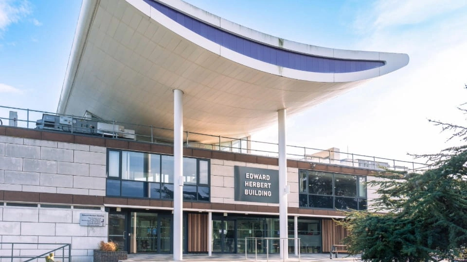 The front entrance of Edward Herbert Building on a sunny day