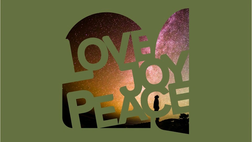Silhouette of a person standing in front of a starry sky with the words 'Love, Joy, Peace' layered over the top.
