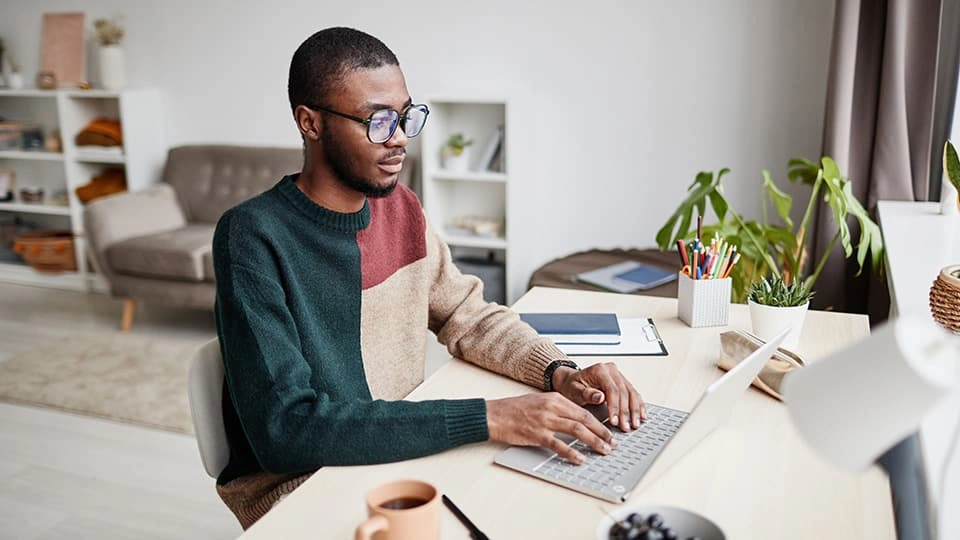 Man working at a laptop at home