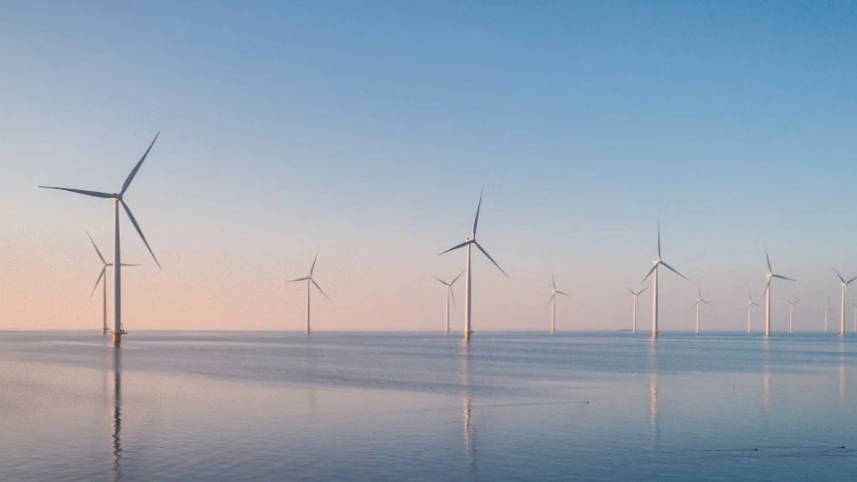 Wind turbines in the sea during sunrise