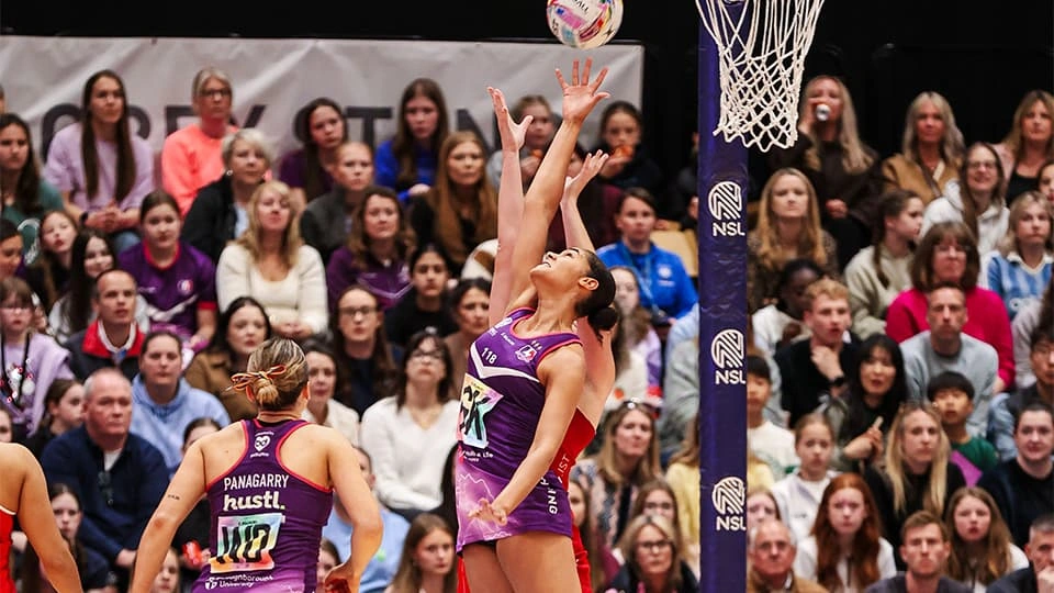 Action shot of Lightning Netball players during a match.