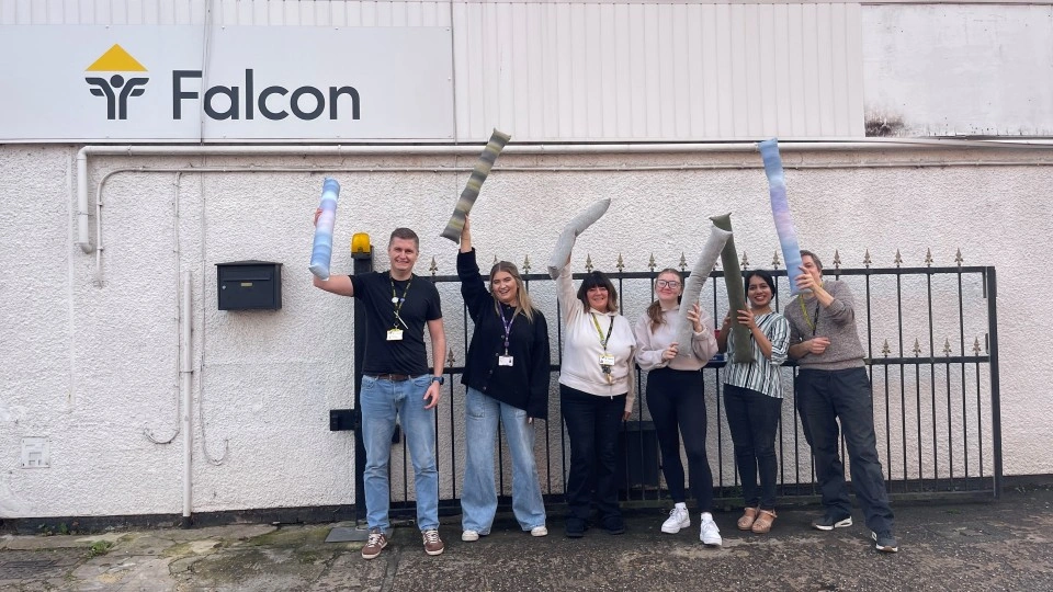 A group of people outside the Falcon Centre