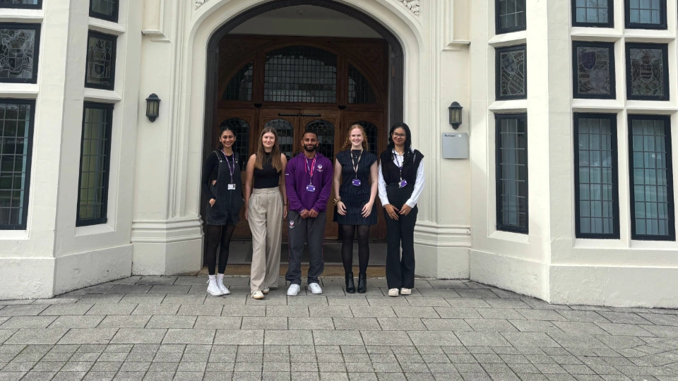 Five new staff members stood in front of Hazlerigg's front entrance