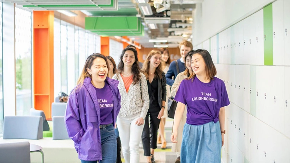 London student representatives walking down a hallway laughing