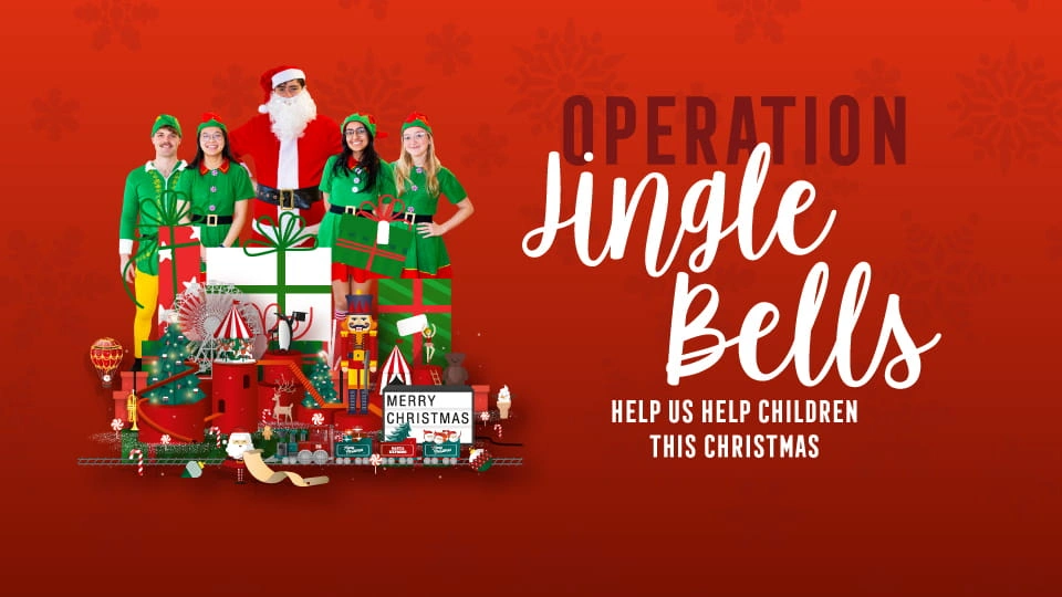 Four people dressed as elves and one dressed as Santa Claus standing behind a pile of toys and the title 'Operation Jingle Bells, help us help children this Christmas'.