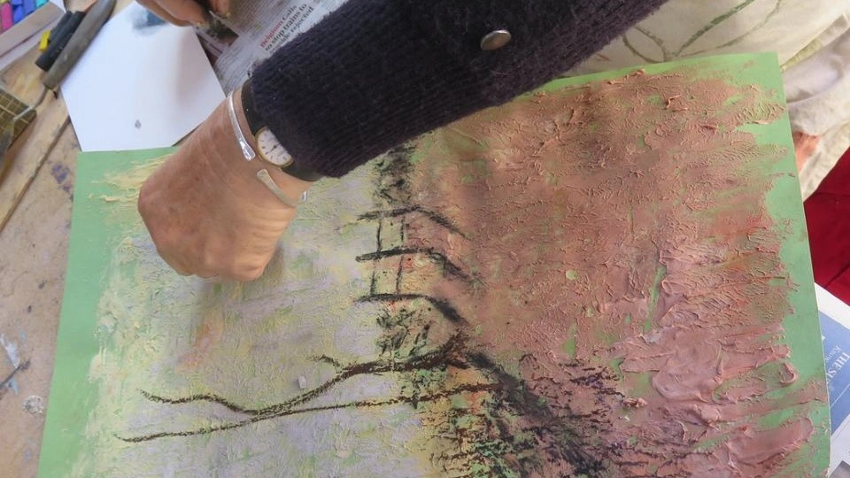 Close-up of a person's hands painting a picture.
