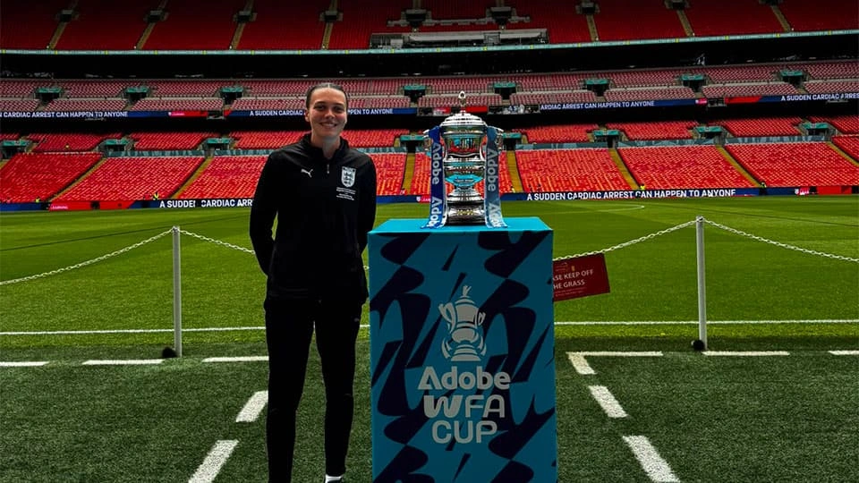 Phoebe Cross next to the Women's FA Cup trophy in Wembley Stadium