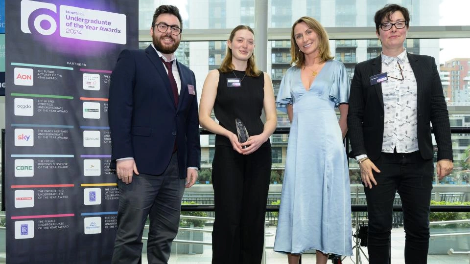 Tilly stood next to award hosts on stage receiving her award