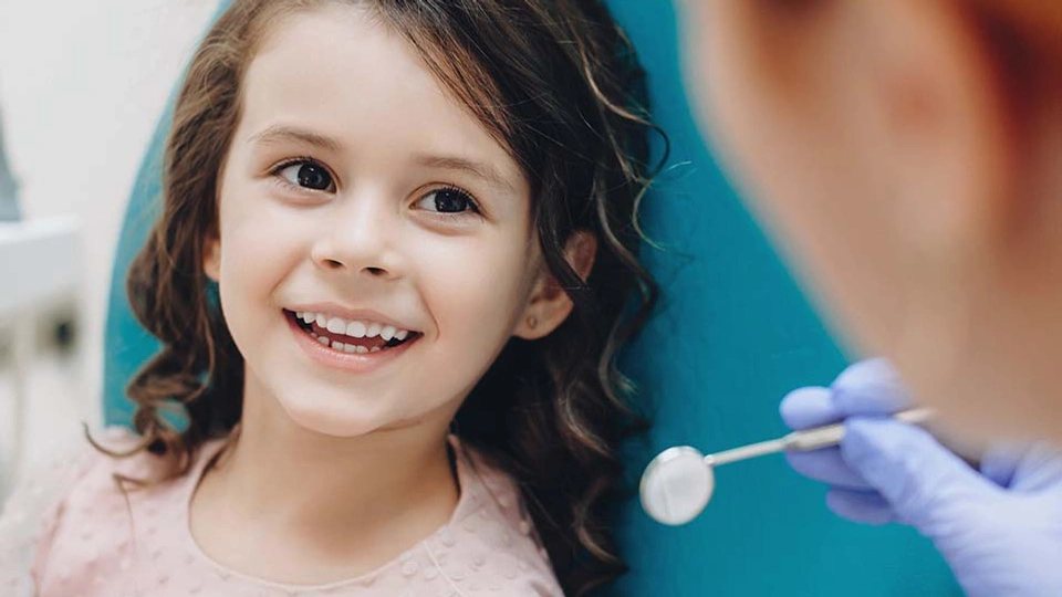 A young girl visits the dentist
