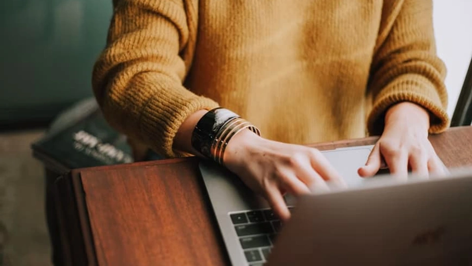 Person types on a laptop
