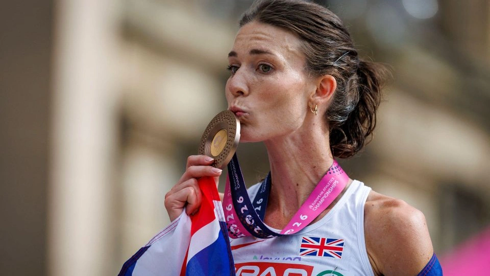 Doctoral Researcher Abbie Donnelly kisses the bronze medal she won in the marathon at the 2026 European Athletics Championships