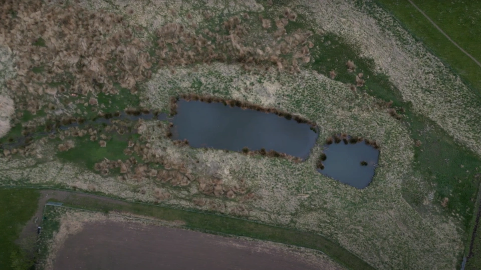 An aerial shot of dual sediment ponds - two small ponds next to each other