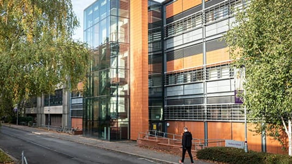 Student walking outside university building