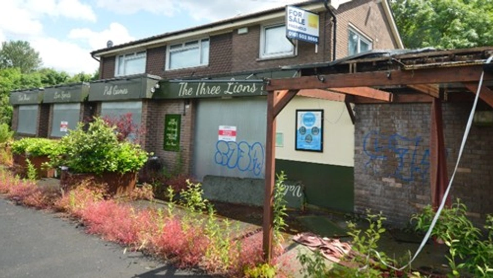 The Three Lions in Meden Vale, Nottinghamshire, looks abandoned with windows boarded up and overgrown foliage