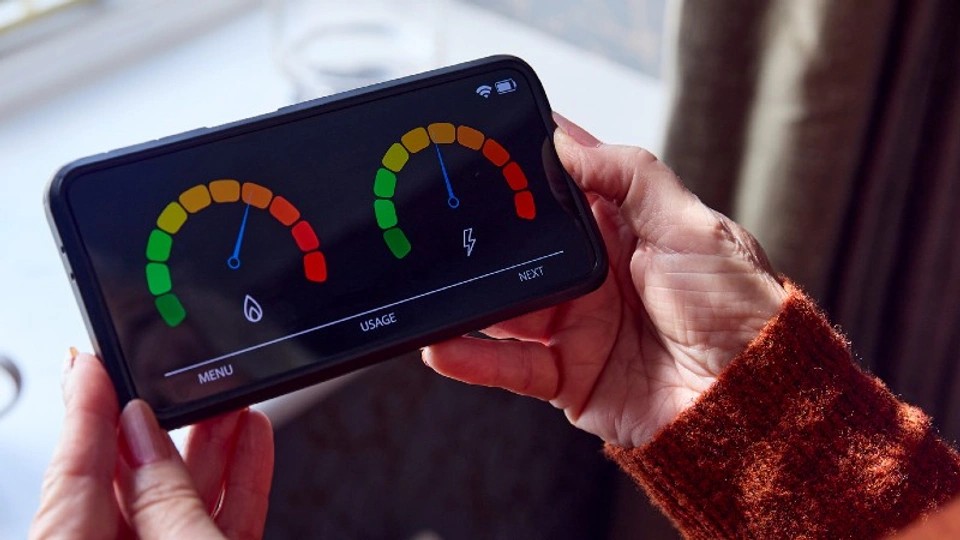 A person holding a smart meter