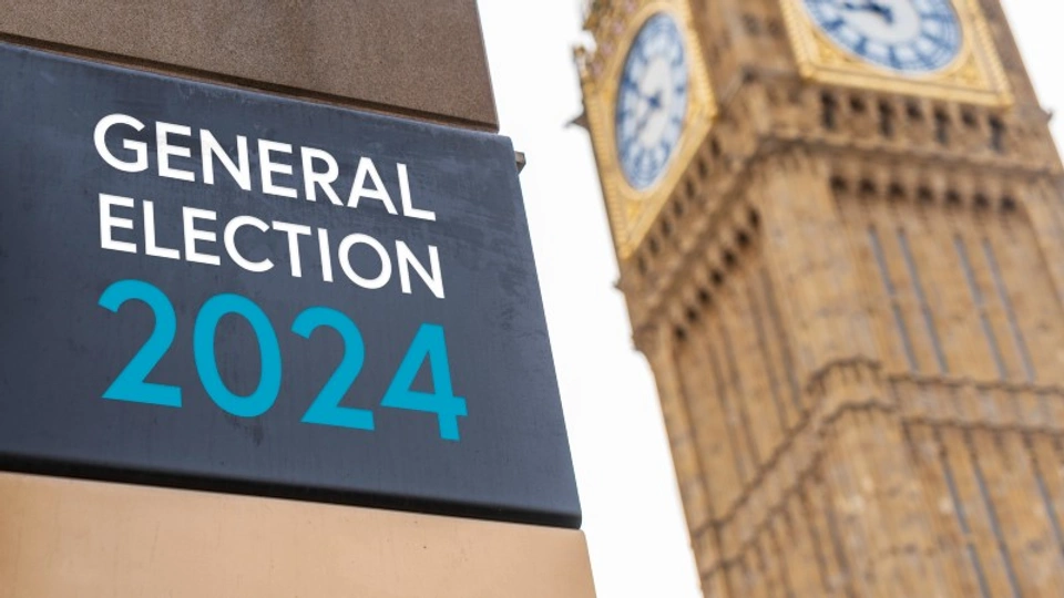 A sign saying General Election 2024 and Elizabeth Tower in London