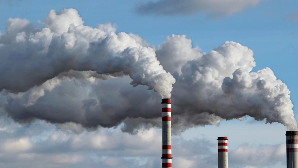 Three towers with plumes of smoke bellowing into the air