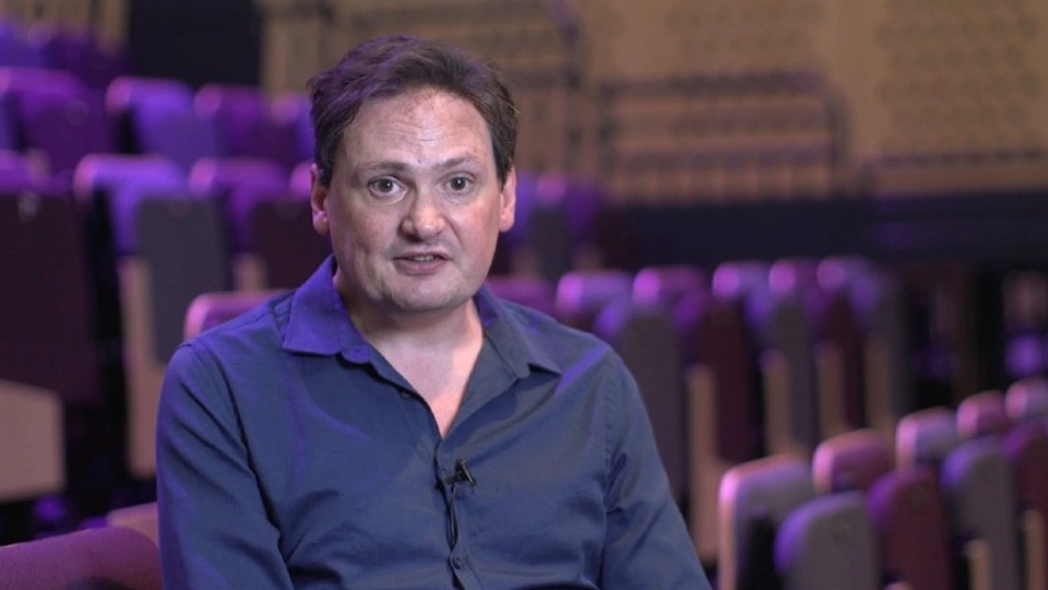 Prof Marcus Collins of Loughborough University sitting in an empty theatre