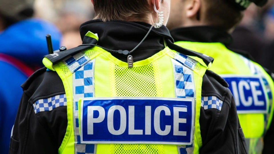 a police officer in uniform with the word police on their hi vis jacket