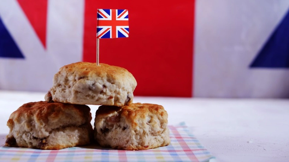 a plate of scones with a union jack flag poking out