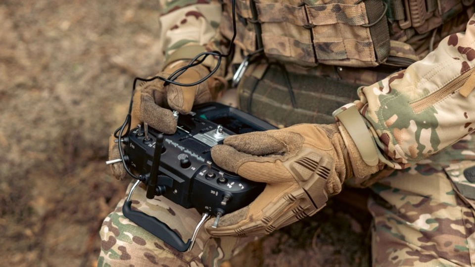 A soldier operates a drone with a controller