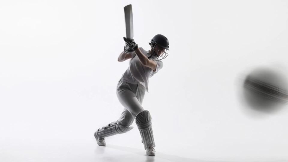 A female cricketer hits the ball